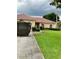 Single-story home with a red tile roof and a large grassy yard at 417 Bay Leaf Dr, Kissimmee, FL 34759