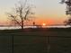 Scenic sunset view over calm lake with gazebo at 535 Minnow Ct, Kenansville, FL 34739