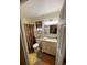 Bathroom with vanity, shower, and patterned curtain at 535 Minnow Ct, Kenansville, FL 34739