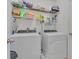 Laundry room with washer, dryer, and storage shelves at 1801 Stargazer Trl, Kissimmee, FL 34758