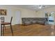 Living area with sectional sofa, hardwood floors, and access to patio at 1801 Stargazer Trl, Kissimmee, FL 34758