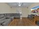 Living room with sectional sofa, hardwood floors, and sliding glass doors at 1801 Stargazer Trl, Kissimmee, FL 34758