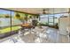 Screened-in patio with outdoor grill and dining table at 1801 Stargazer Trl, Kissimmee, FL 34758