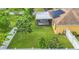Backyard with lush landscaping, screened patio, and white fence at 1801 Stargazer Trl, Kissimmee, FL 34758