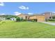 One-story house with a large yard, driveway, and two-car garage at 1801 Stargazer Trl, Kissimmee, FL 34758