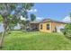 Landscaped backyard with screened patio and lush lawn at 1801 Stargazer Trl, Kissimmee, FL 34758