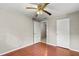 Simple bedroom with wood floors, ceiling fan, and ample closet space at 2800 S Park Ave, Sanford, FL 32773
