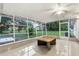 Relaxing screened porch with granite table and backyard view at 2800 S Park Ave, Sanford, FL 32773