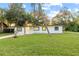 Ranch-style home with white exterior, black trim, and a green lawn at 2800 S Park Ave, Sanford, FL 32773