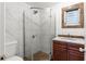 Bathroom with wood vanity, shower, and white tile at 2800 S Park Ave, Sanford, FL 32773
