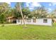 White house with black trim and a spacious yard at 2800 S Park Ave, Sanford, FL 32773