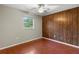 Bedroom with hardwood floors and wood paneled wall at 2800 S Park Ave, Sanford, FL 32773