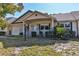 Tan house with green accents, covered porch, and landscaped yard at 8872 Sw 92Nd Pl # E, Ocala, FL 34481