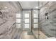 Spa-like bathroom featuring a walk-in shower with marble tile and glass enclosure at 444 Quay Assisi, New Smyrna Beach, FL 32169