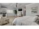 Main bedroom with king bed, plant, and ensuite bathroom access at 444 Quay Assisi, New Smyrna Beach, FL 32169