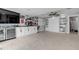 Open living space with a wall-mounted TV, built-in cabinets, and murphy bed at 444 Quay Assisi, New Smyrna Beach, FL 32169