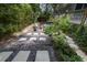Landscaped backyard with fire pit, stone pathways, and lush greenery at 582 Caledonia Pl, Sanford, FL 32771