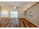 Bright living room with vaulted ceilings, wood-look floors, and sliding glass doors at 582 Caledonia Pl, Sanford, FL 32771