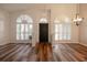 Bright and airy entryway with wood-look floors, arched windows, and elegant light fixtures at 582 Caledonia Pl, Sanford, FL 32771