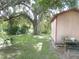 Large backyard with mature trees and storage shed at 1060 E Tee Cir, Bartow, FL 33830