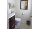 Clean bathroom with dark vanity and tile flooring at 1060 E Tee Cir, Bartow, FL 33830