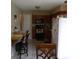 Bright kitchen with wood cabinets, tile floor, and breakfast bar at 1060 E Tee Cir, Bartow, FL 33830