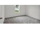Spacious bedroom featuring gray carpeting and a window at 3422 Sw 165Th Loop, Ocala, FL 34473