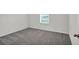 Bright bedroom with gray carpeting and a window at 3422 Sw 165Th Loop, Ocala, FL 34473
