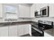 Modern kitchen with stainless steel appliances and gray countertops at 1122 James Paul Rd, Davenport, FL 33837