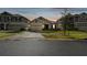 Two-story house exterior at dusk with a two-car garage at 1122 James Paul Rd, Davenport, FL 33837