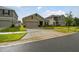 Tan two-car garage house with landscaping and driveway at 1122 James Paul Rd, Davenport, FL 33837
