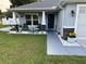 Inviting front porch with blue door, stone accents, and comfortable seating at 10470 Sw 132Nd Ct, Dunnellon, FL 34432