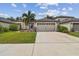 One-story house with attached garage and neatly landscaped front yard at 6294 Manitoba Dr, Lakeland, FL 33805