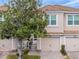 Two-story townhome with attached garage and landscaping at 8311 Foster Dr, Davenport, FL 33896