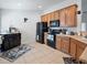 Kitchen with wood cabinets, black appliances, and tile floor at 8311 Foster Dr, Davenport, FL 33896