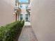 Brick paved walkway between townhomes, lush landscaping at 8311 Foster Dr, Davenport, FL 33896