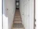 Interior entry with carpeted stairs and door at 8311 Foster Dr, Davenport, FL 33896