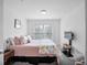 Guest bedroom with a queen-size bed and stylish decor at 8311 Foster Dr, Davenport, FL 33896