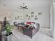 Spacious living room with leather sofas and large TV at 8311 Foster Dr, Davenport, FL 33896