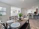 Open dining area with a dark wood table and four chairs at 8311 Foster Dr, Davenport, FL 33896