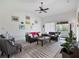 Open living room, leather sofas, and wall decor at 8311 Foster Dr, Davenport, FL 33896