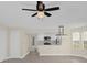 Open concept living room with kitchen access and ceiling fan at 2040 Royal Bay Blvd # 31, Kissimmee, FL 34746