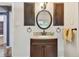 Bathroom with vanity, oval mirror and dark wood cabinets at 215 Young Pl, Lakeland, FL 33803