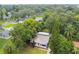 Aerial view of a charming house nestled among lush greenery at 215 Young Pl, Lakeland, FL 33803