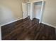 Second bedroom with dark hardwood floors and a large closet at 2501 Gulfstream Rd, Orlando, FL 32805