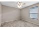 Simple bedroom with carpeted floors and ceiling fan at 14234 Lanikai Beach Dr, Orlando, FL 32827