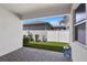 Covered patio with brick pavers, small yard, and view of neighboring house at 14234 Lanikai Beach Dr, Orlando, FL 32827