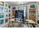 Home office with a large monitor, built-in shelves, and inspiring decor at 14234 Lanikai Beach Dr, Orlando, FL 32827