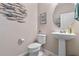 Powder room with pedestal sink and toilet at 14234 Lanikai Beach Dr, Orlando, FL 32827