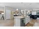 Modern kitchen with white cabinets, a large island, and stainless steel appliances at 14234 Lanikai Beach Dr, Orlando, FL 32827